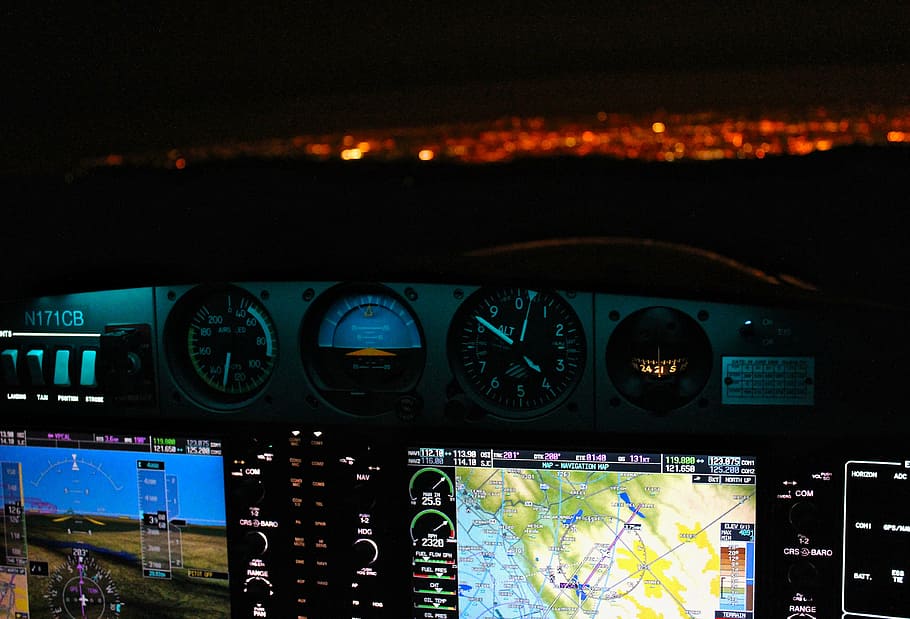 airplane digital and analog panels at night, navigation, system