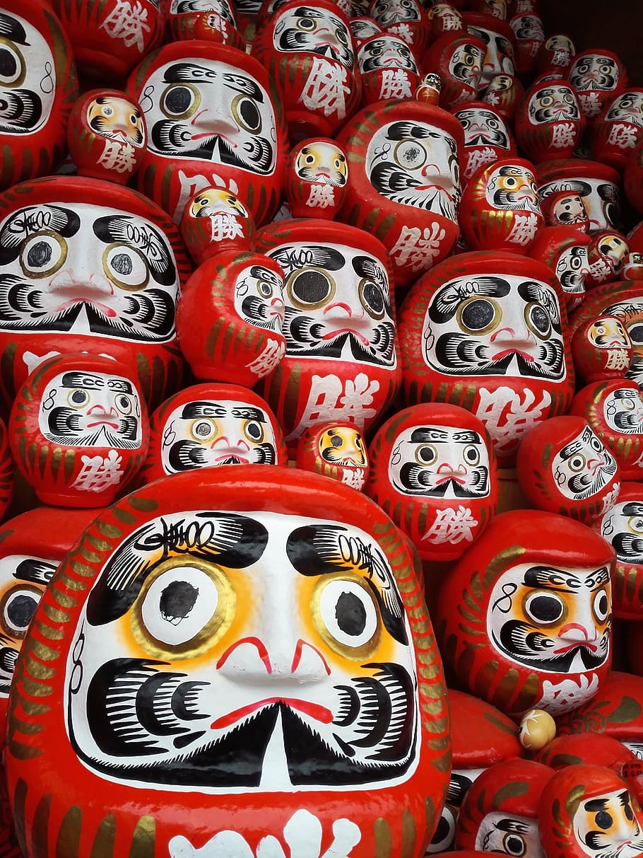 stack of white-and-red masks, dharma, daruma doll, tumbling doll