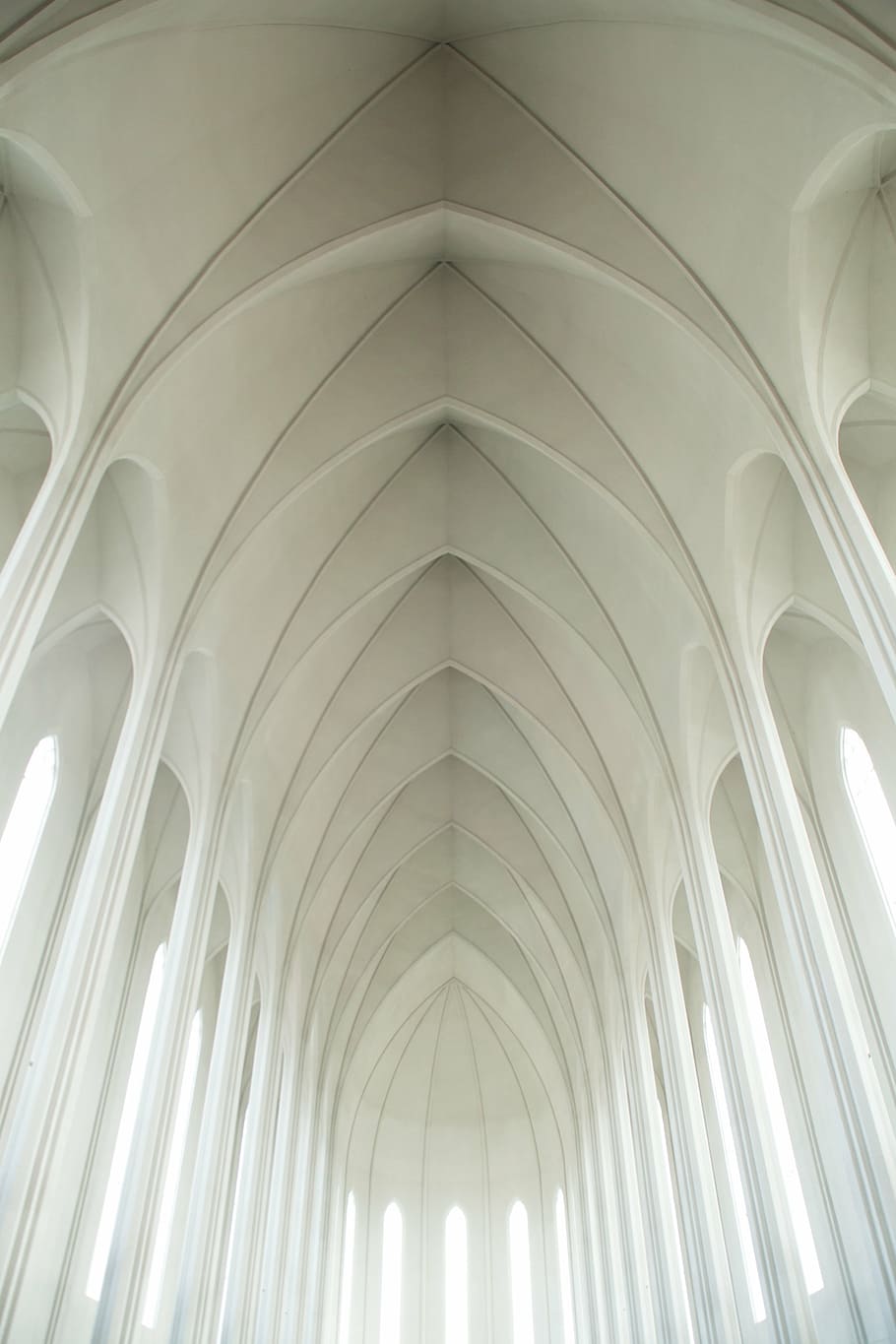 low-angle photography of triangular building interior, white