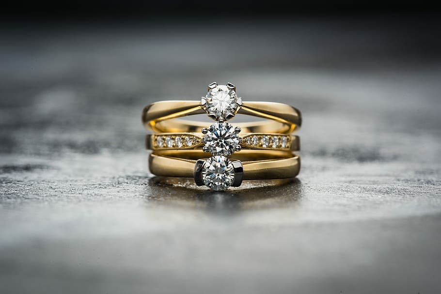 gold-colored clear gemstone trio ring, three gold-colored clear gemstone on concrete surface, HD wallpaper