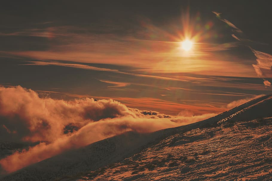 grayscale photo of sun's ray above the clouds, ground covered with clouds at sunset HD wallpaper