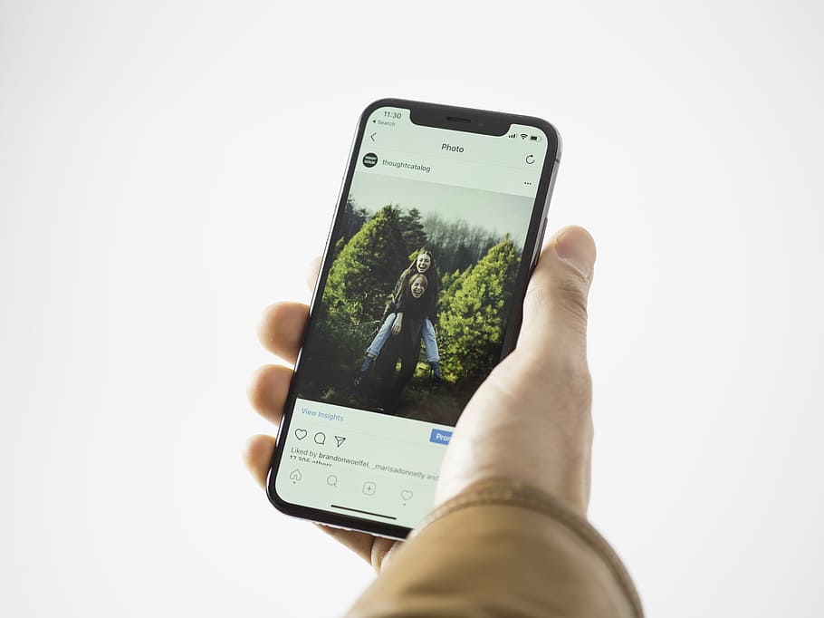 person using black smartphone, person holding space gray iPhone X HD wallpaper