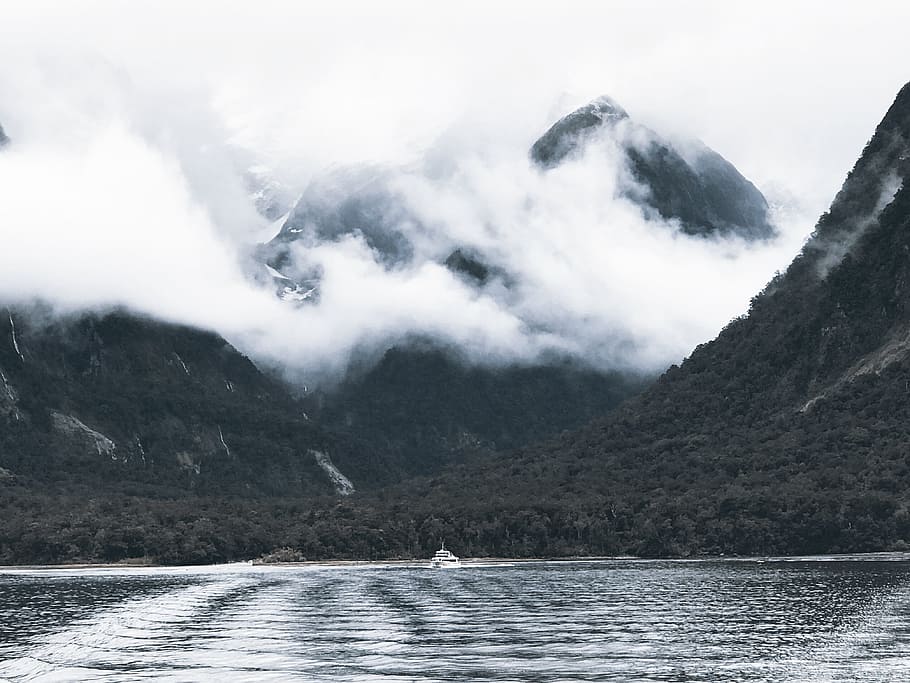 Photography of Body of Water Surrounded by Mountains and Fogs HD wallpaper