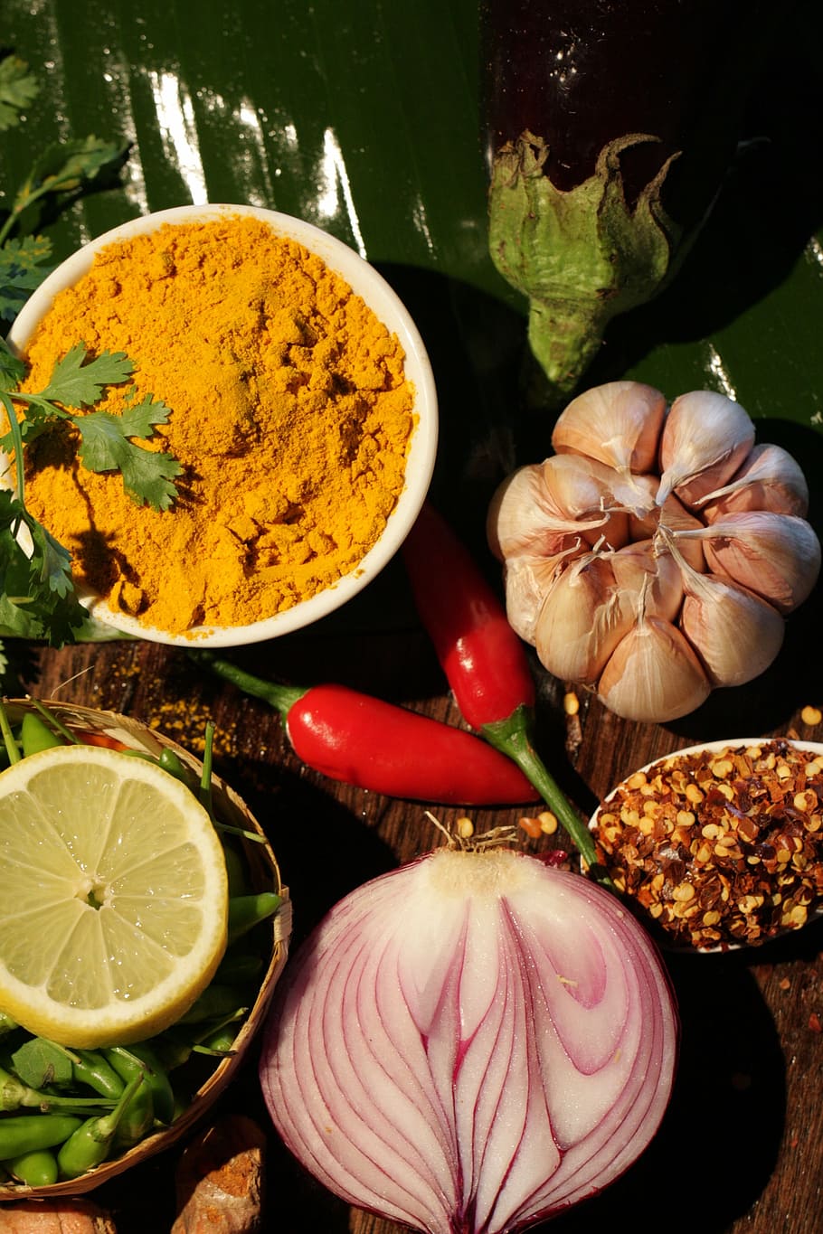 spice powder, lemon, chilli pepper, garlic bulb, and sliced of onion HD wallpaper