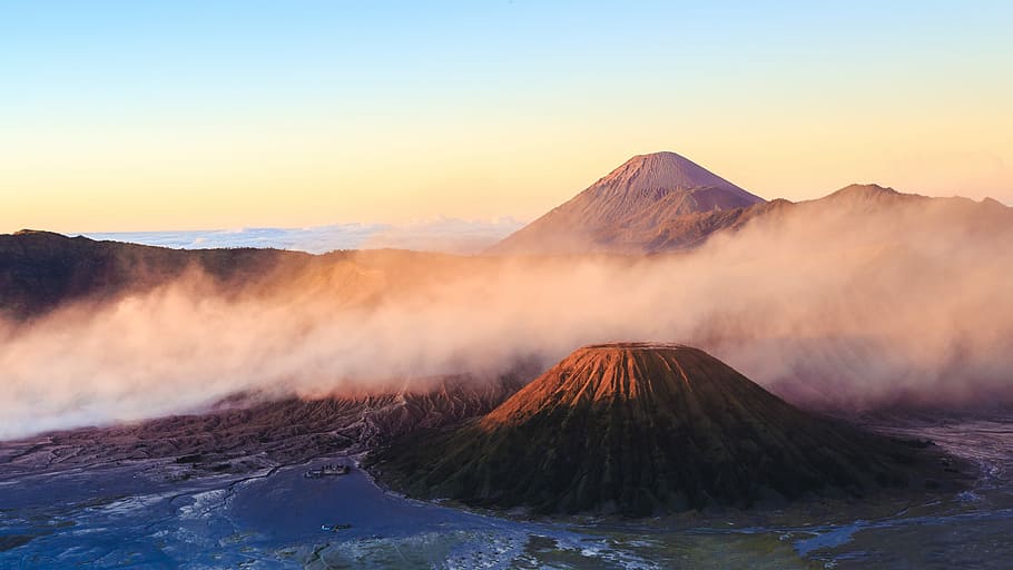 mountain under clouds near body of wate, mountain ranges covered in white fog HD wallpaper