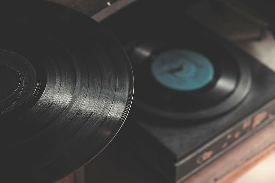 closeup photo of black vinyl record near turntable, disc, still