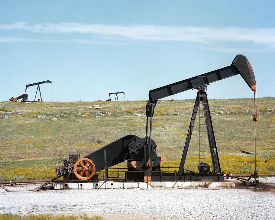 gray industrial machine on field during daytime, oil pump jacks