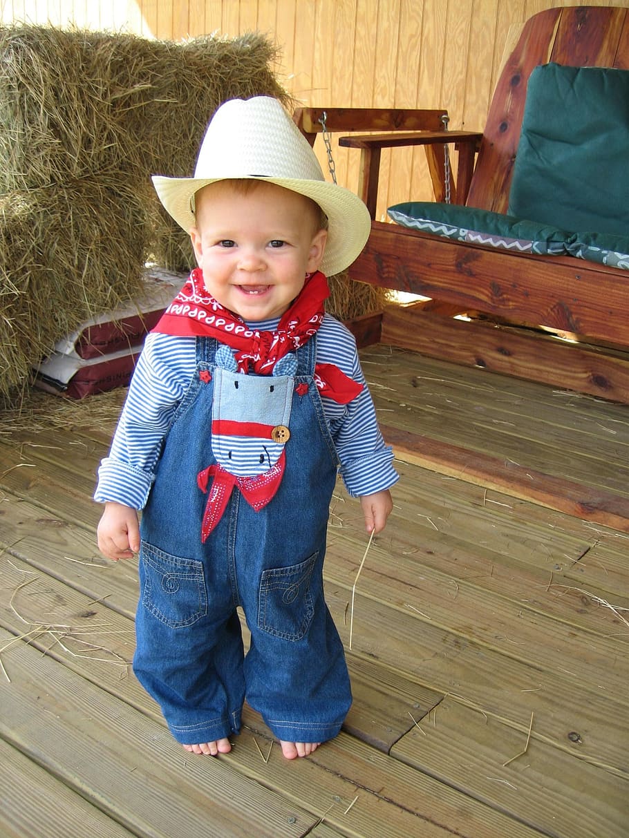 closeup photo of toddler in blue denim jumper pants, cowboy, suit