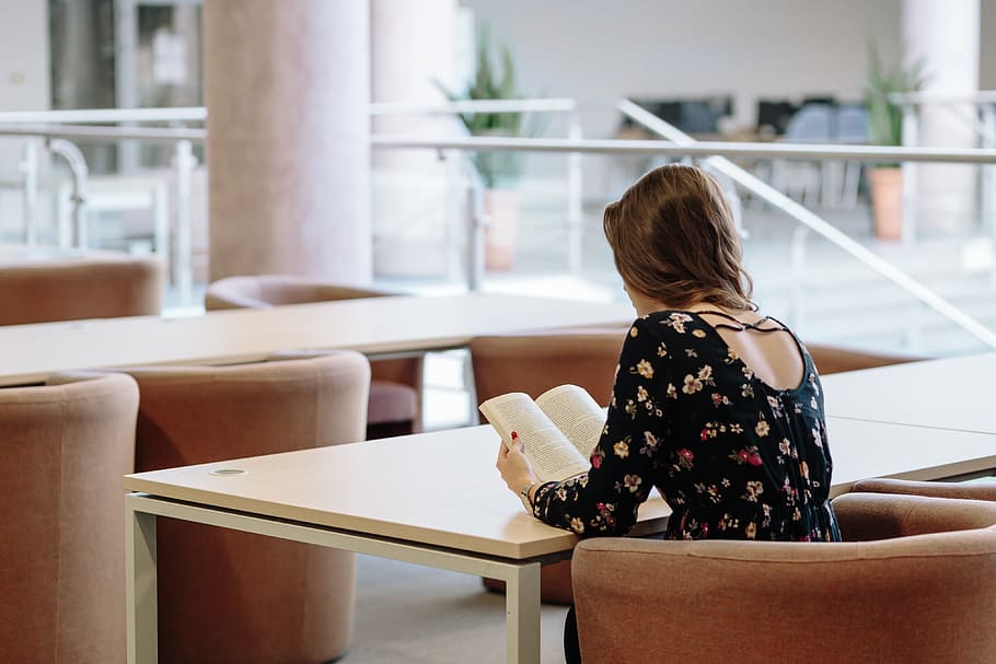 woman in black long-sleeved top reading a book, table, chairs HD wallpaper