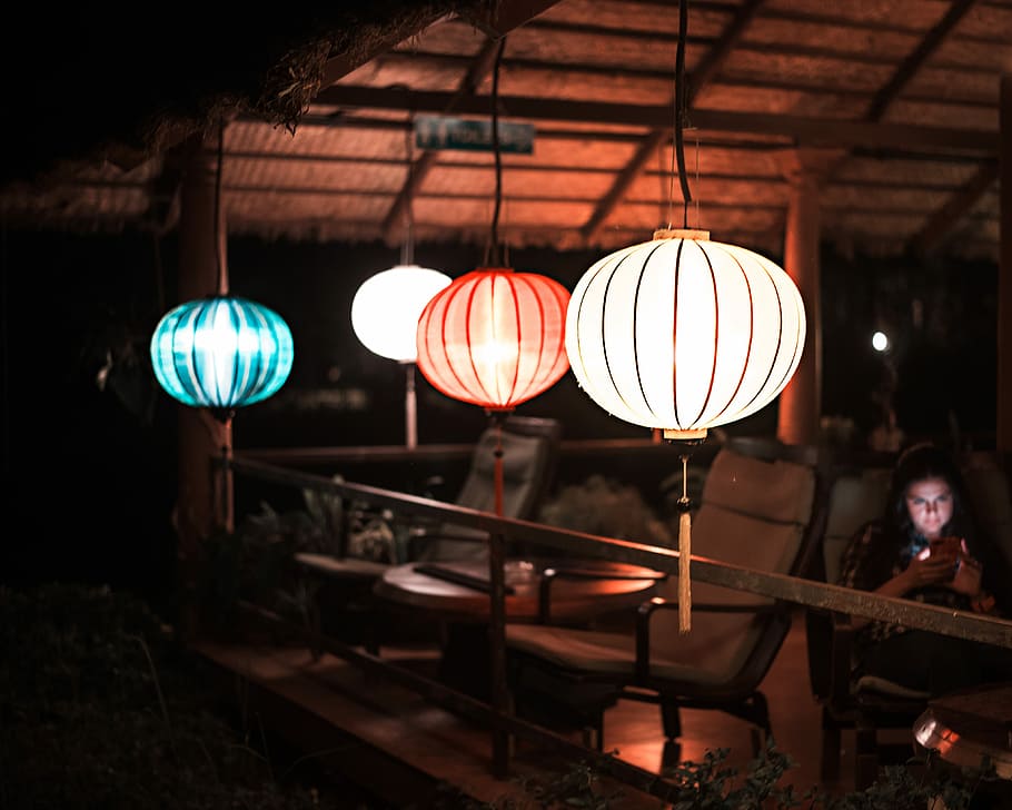 woman sitting on lounger near pendant lamps, lantern, lights HD wallpaper