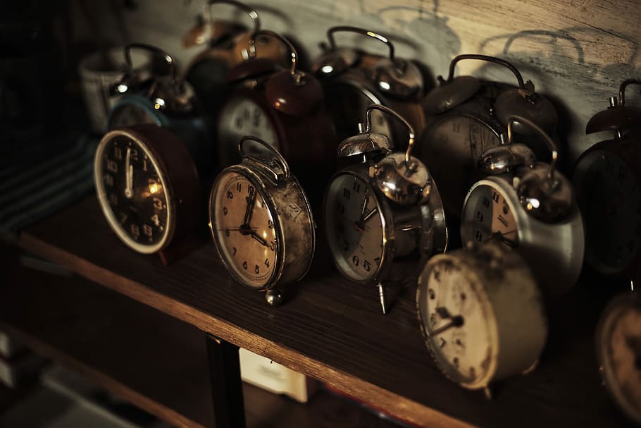 photo of analog alarm clock lot, assorted round gray metal alarm clocks on table HD wallpaper