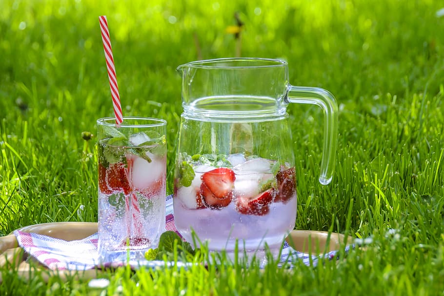 fruit juice in clear glass pitcher with drinking glass on green grass, HD wallpaper