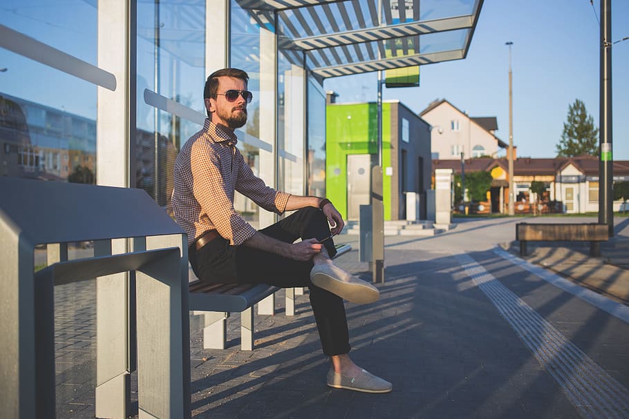 man sitting on bench, person, street, waiting shed, one person HD wallpaper