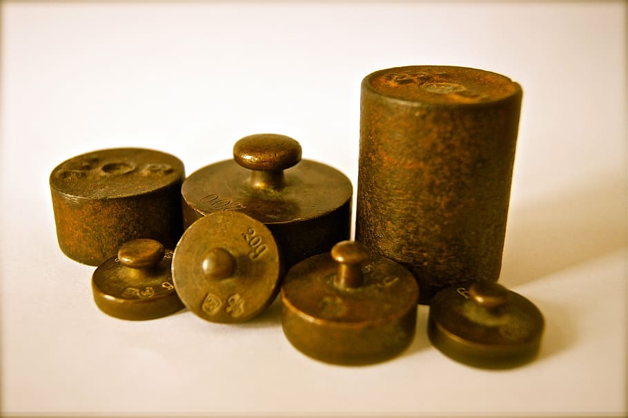 close-up photo of several copper ornaments, weights, iron, kilo HD wallpaper