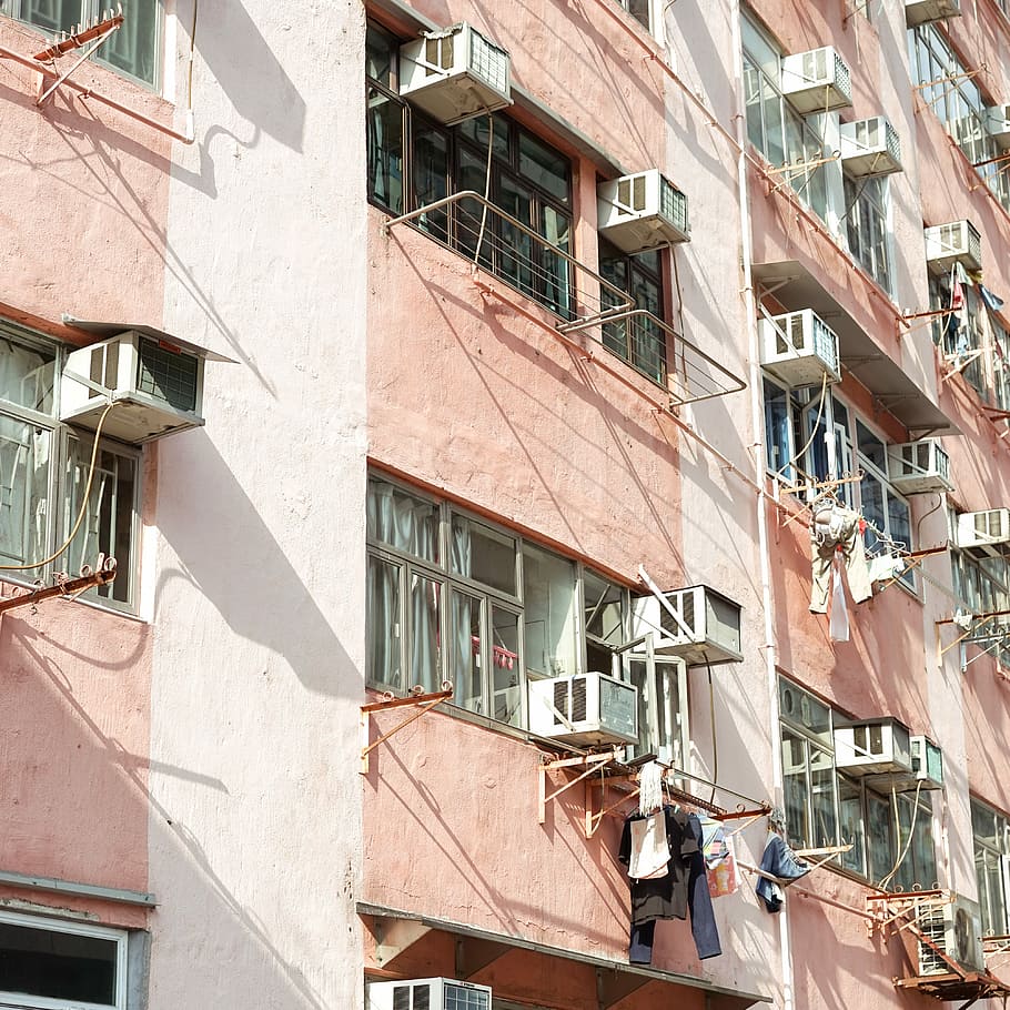 white apartment building, concrete building with air conditioners