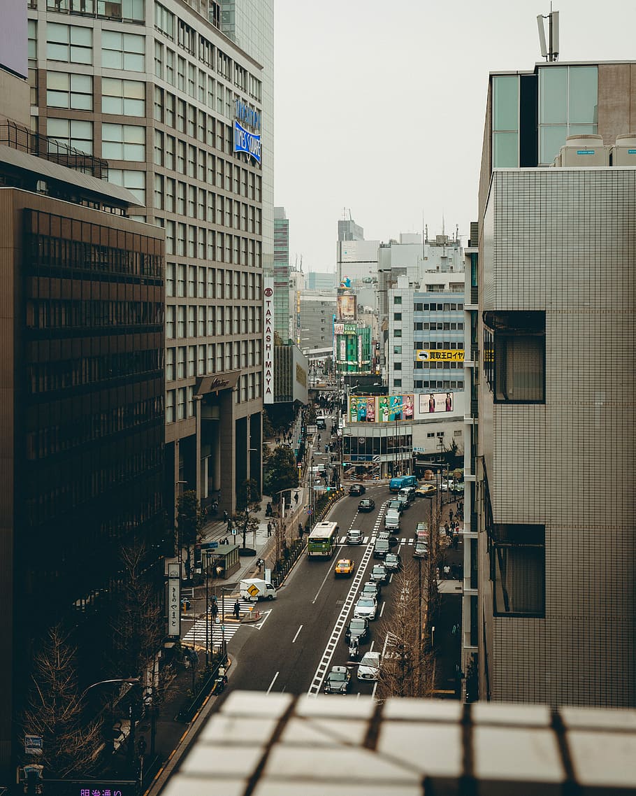 a view of busy street on a terrace, aerial photo of city buildings