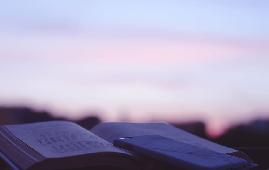 smartphone with case on top of opened book, gray, daytime, reading HD wallpaper