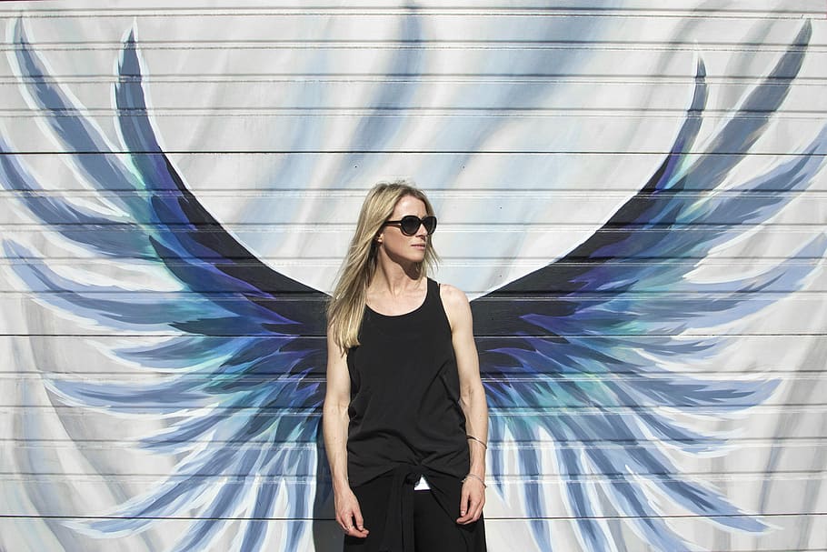 HD wallpaper: woman taking photo near wings painted wall, woman in black  tank top standing in front of wall with wings paints | Wallpaper Flare