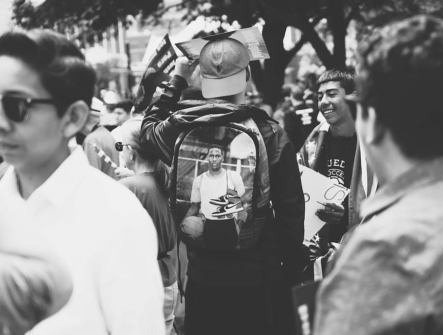 man wearing backpack near people, grayscale photography of man carrying backpack HD wallpaper