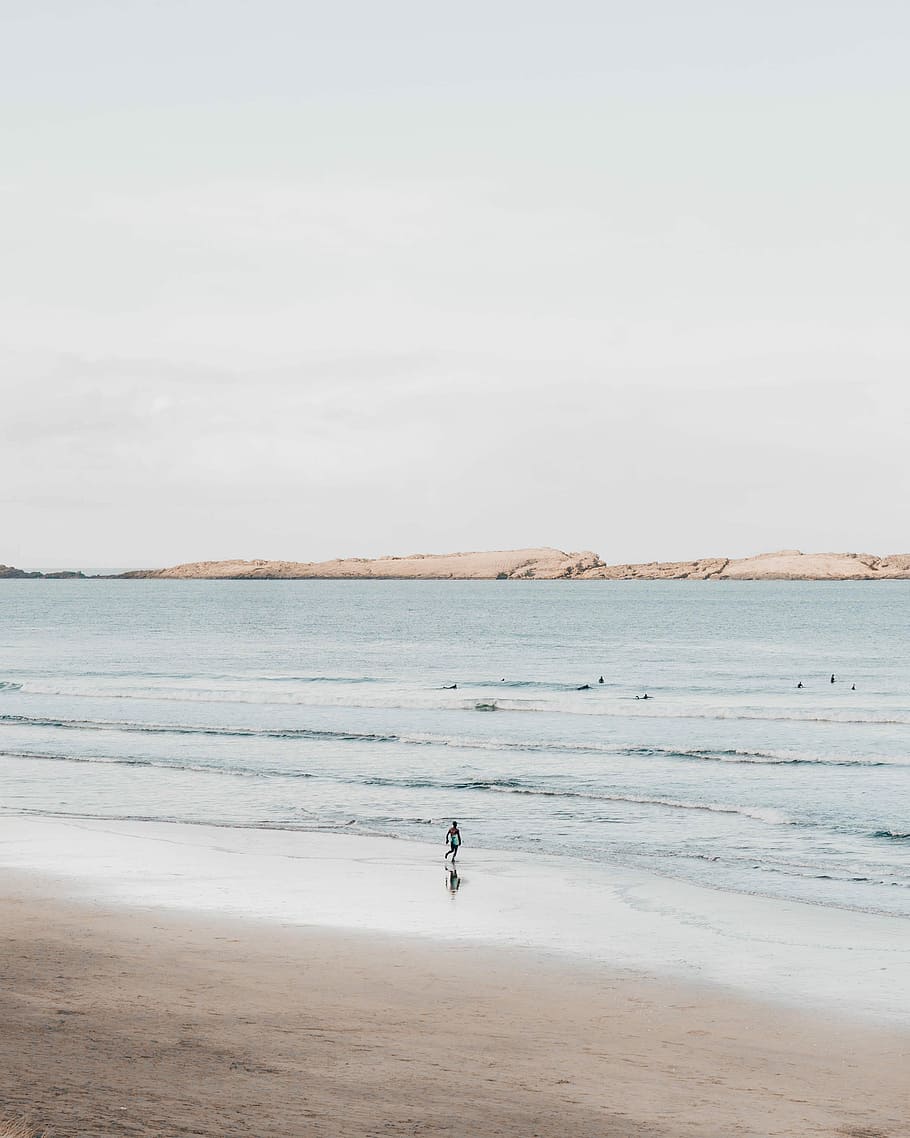 person running on shore, person walking on the beach during daytime HD wallpaper