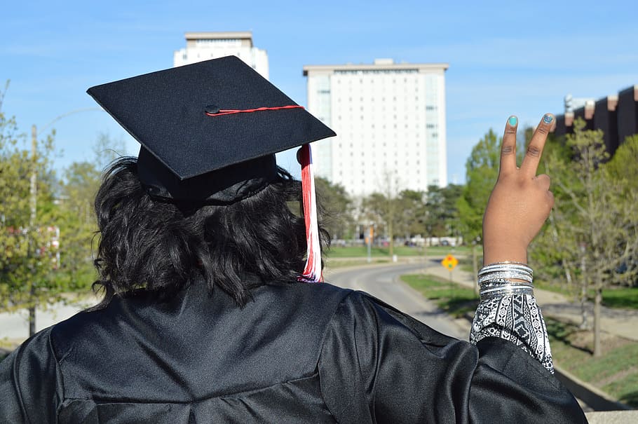 man in black graduation gown making a peace sign, college, rear view HD wallpaper