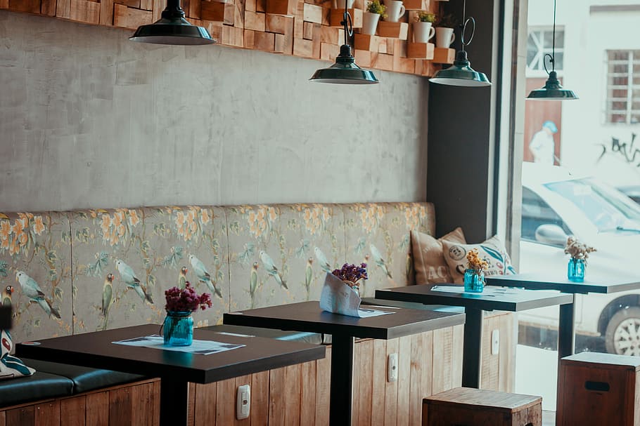 clear blue glass jar on table in store, pile of brown wooden tables under black pendant lamp HD wallpaper