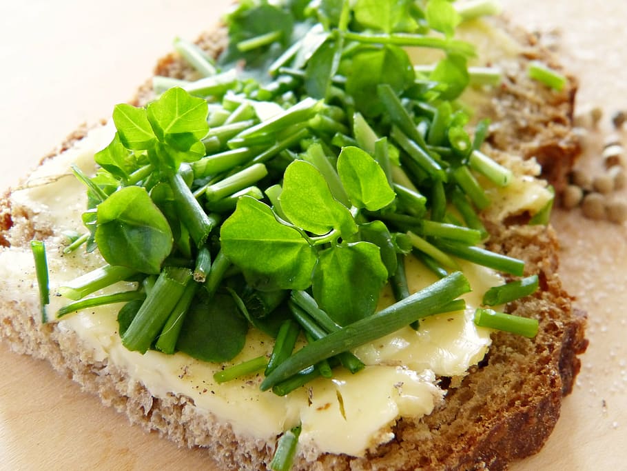 sliced vegetables on wheat breads, watercress, chives, bread and butter
