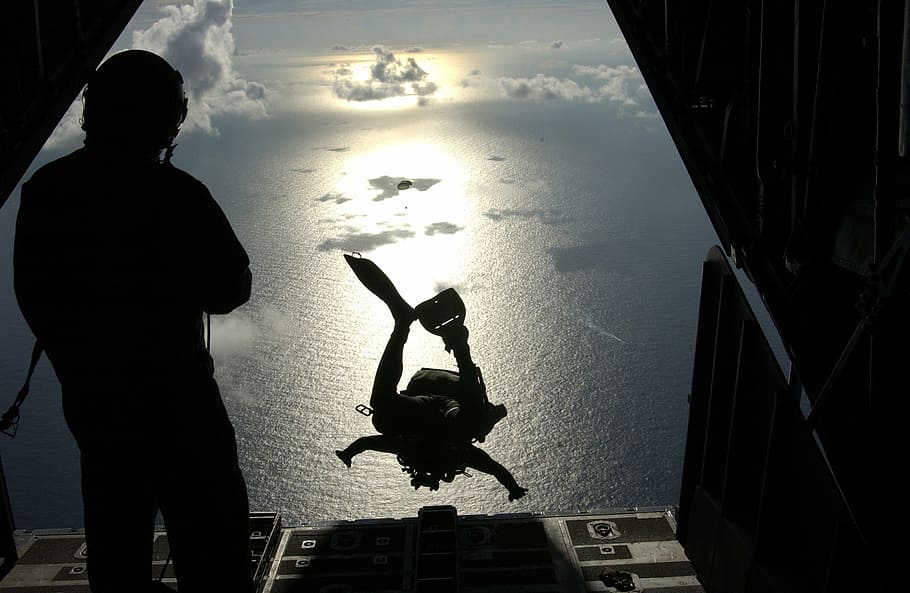 silhouette photo of person dived from the plane, pararescueman
