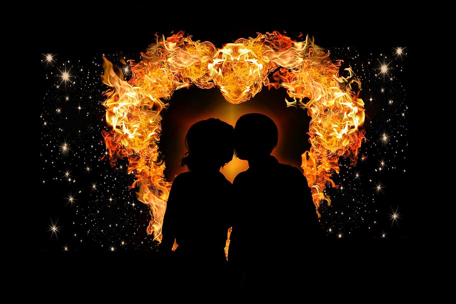 silhouette of two person with flame as back drop, heart, love