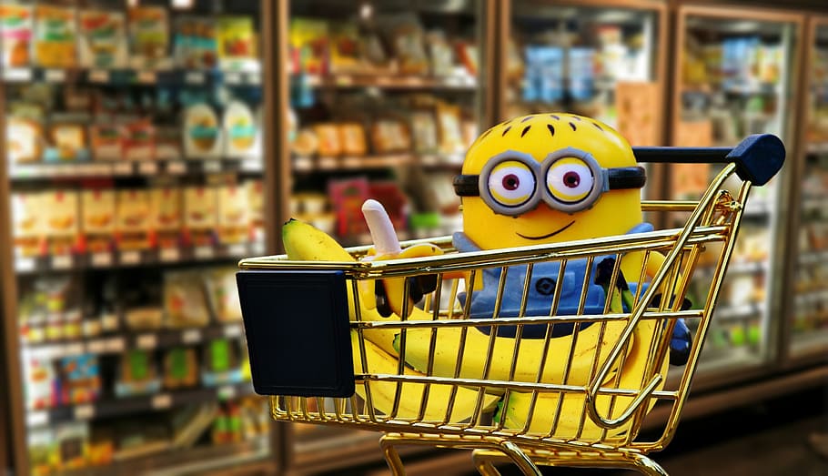 minion plush toy on gold shopping cart, banana, fruit, healthy