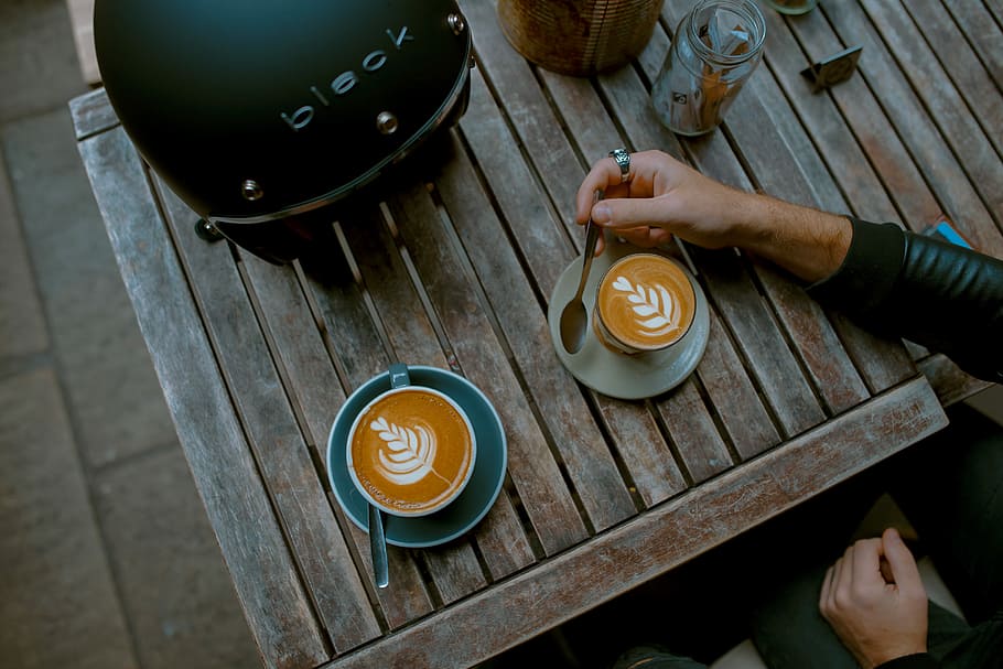 cappuccino near helmet, cappuccino in beige ceramic cup, cafe table HD wallpaper