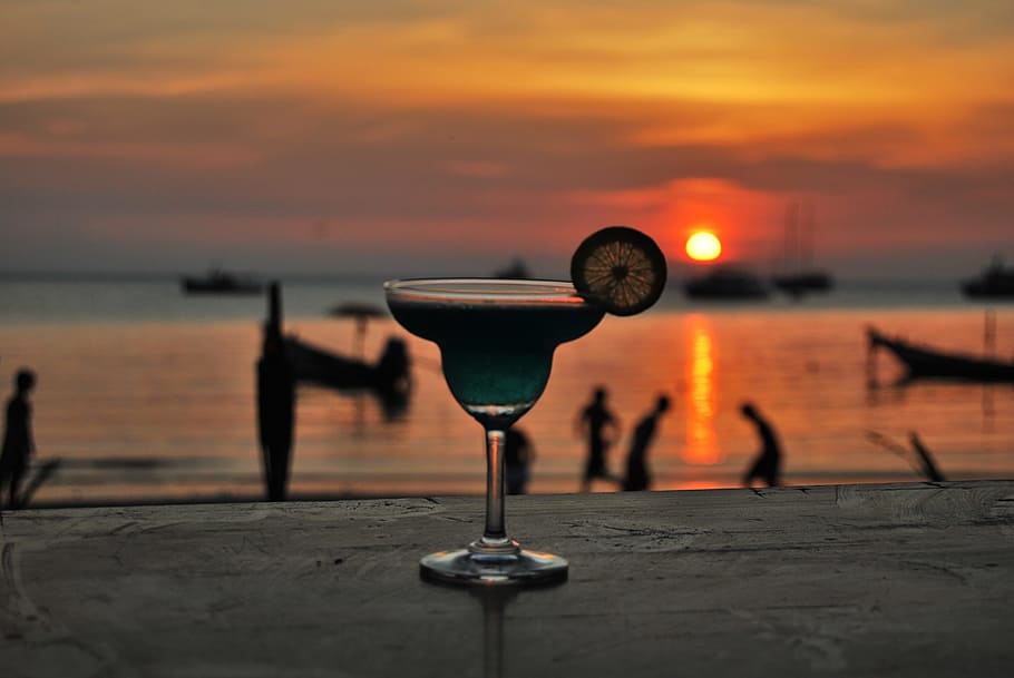 margarita glass filled with liquid during golden hour, blue HD wallpaper