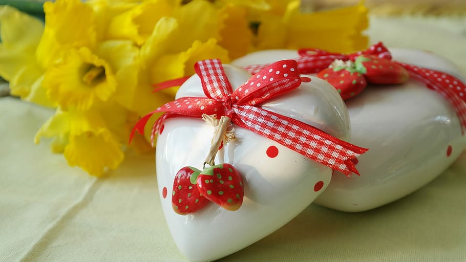 two white ceramic hearts with red ribbons wrapped on it, love gift HD wallpaper