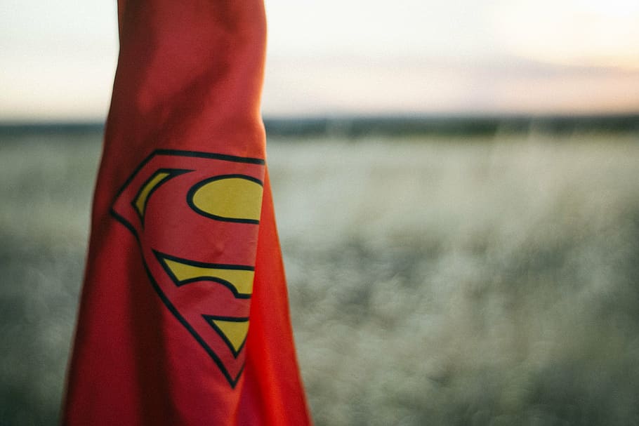 selective focus photography of red Superman coat, cape, water