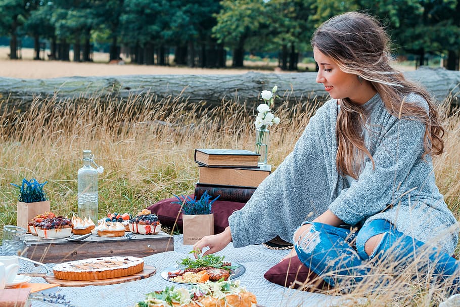 woman sitting on mat with food, outdoor, tree, book, nomad HD wallpaper