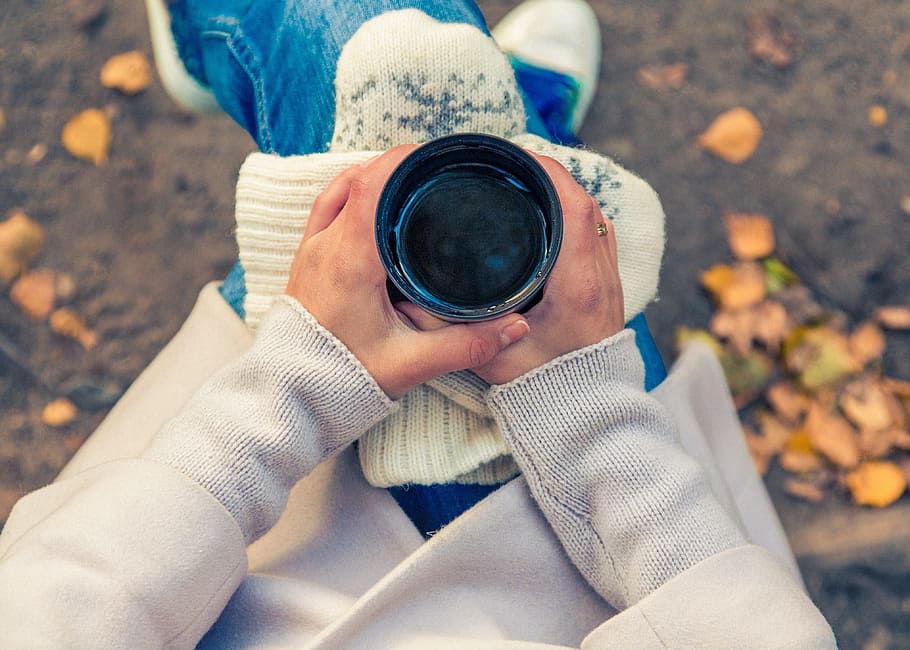 person holding black cup while sitting on chair, beverage, hands holding HD wallpaper