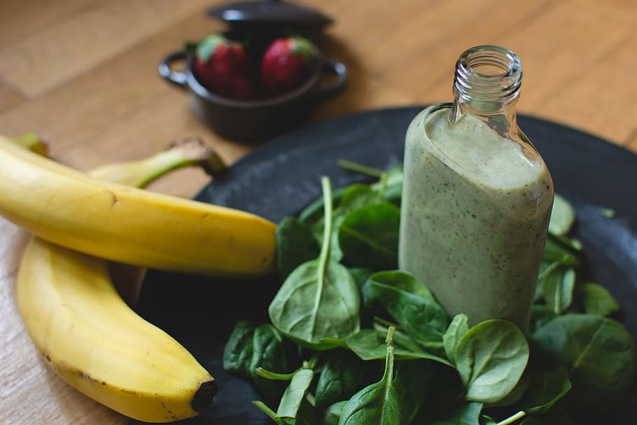 Homemade green smoothie with ingredients, banana, close up, drink