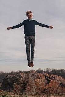 man jumping while open arms, man levitate during daytime, brown haired HD wallpaper