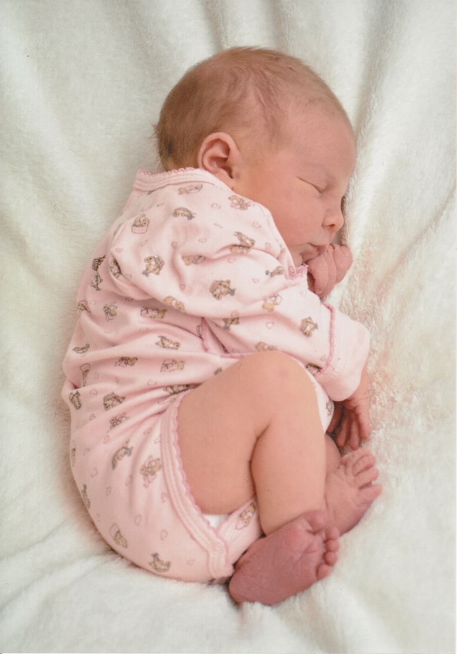 baby wearing pink onesie, birth, newborn, girl, blanket, romper