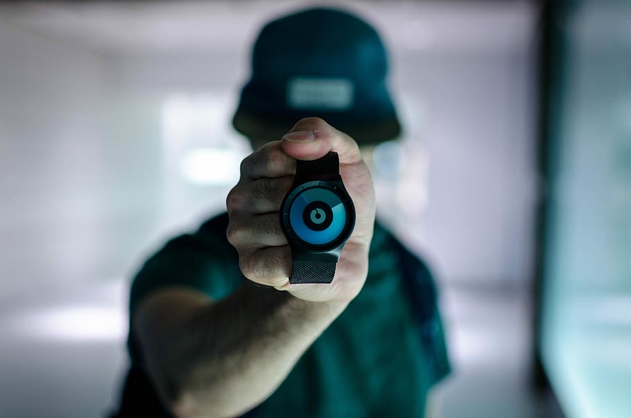 man holding black Ziiiro watch, person holding round black watch in shallow focus photography HD wallpaper