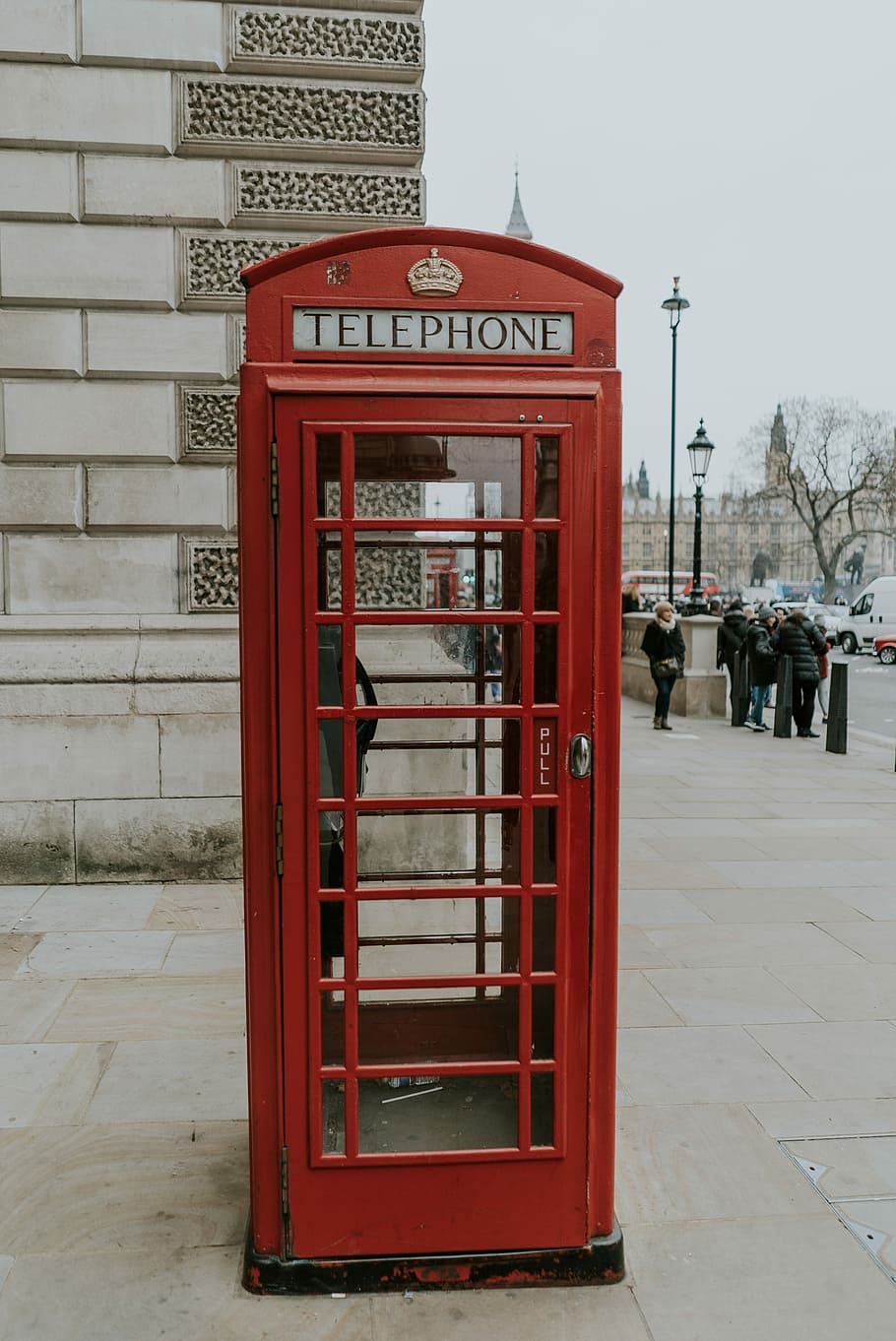 red telephone booth, red telephone booth near wall, phone box