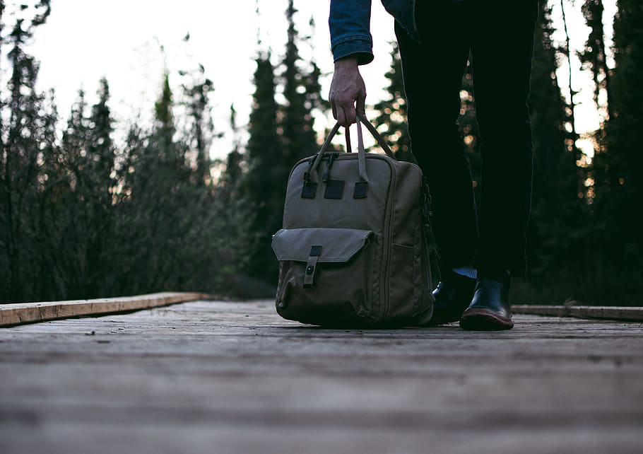 person standing on road while carrying backpack, person carrying gray bag HD wallpaper