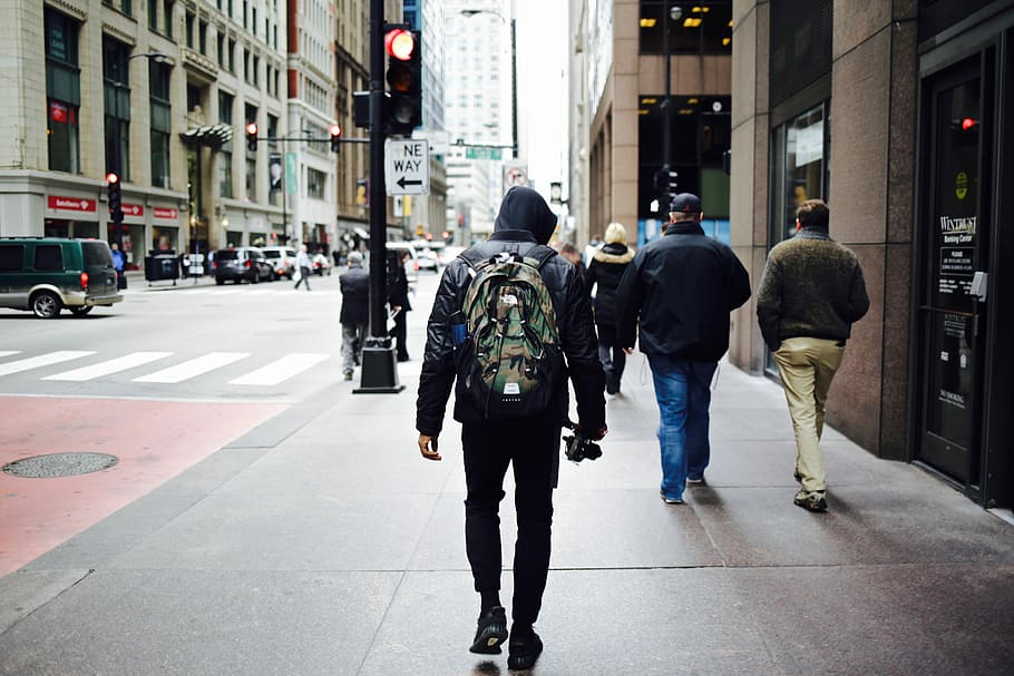 men walking on pathway beside building, man wearing backpack walking on the street HD wallpaper