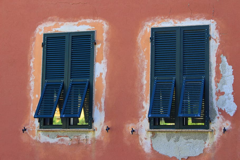 two blue windows on orange wall, two black wooden louvered doors\] HD wallpaper