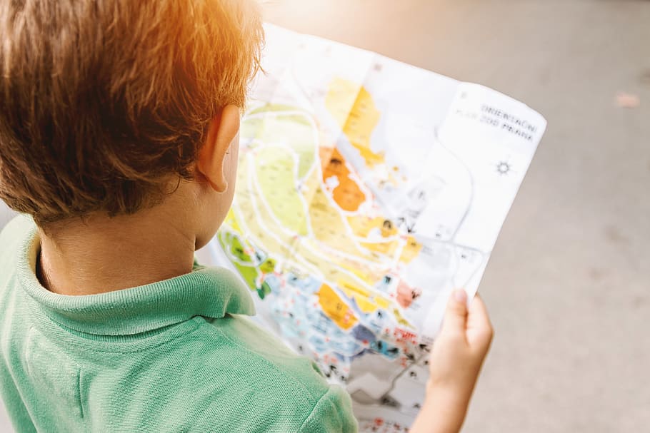boy in green polo shirt reading map during daytime, child, children HD wallpaper
