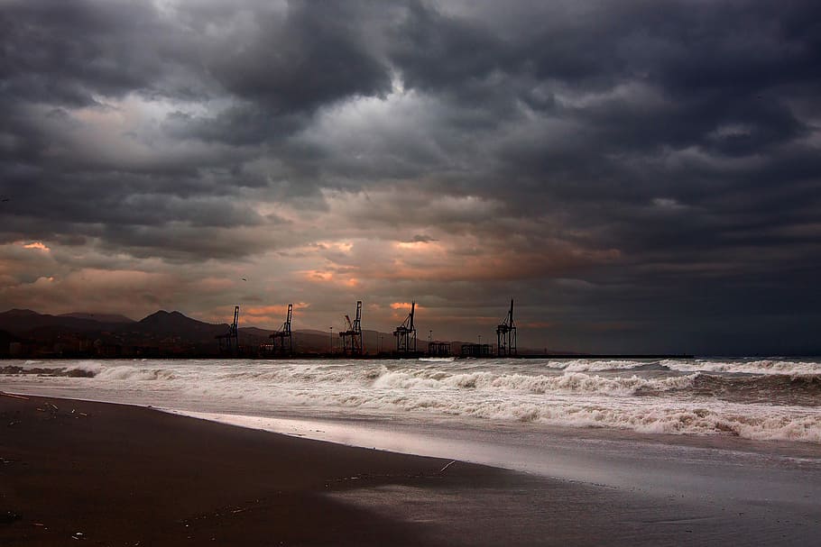 sea waves hitting shoreline, towers across the shore, cloud, overcast HD wallpaper