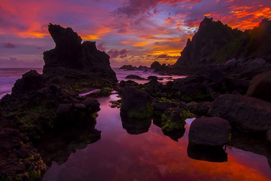 photo of rock formations under red sky, rock formations on sea during dusk HD wallpaper