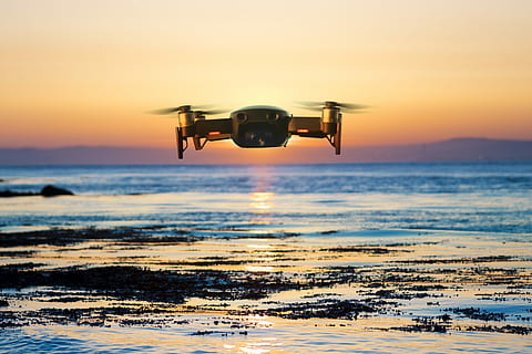 flying quadcopter drone, brown quadcopter flying during sunset HD wallpaper