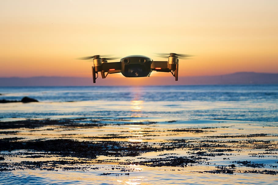 flying quadcopter drone, brown quadcopter flying during sunset HD wallpaper
