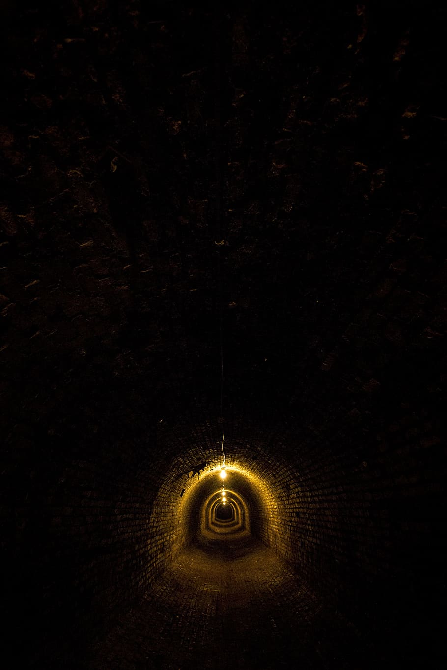 yellow lamp hanging on ceiling, asylum, tunnel, underground, brick